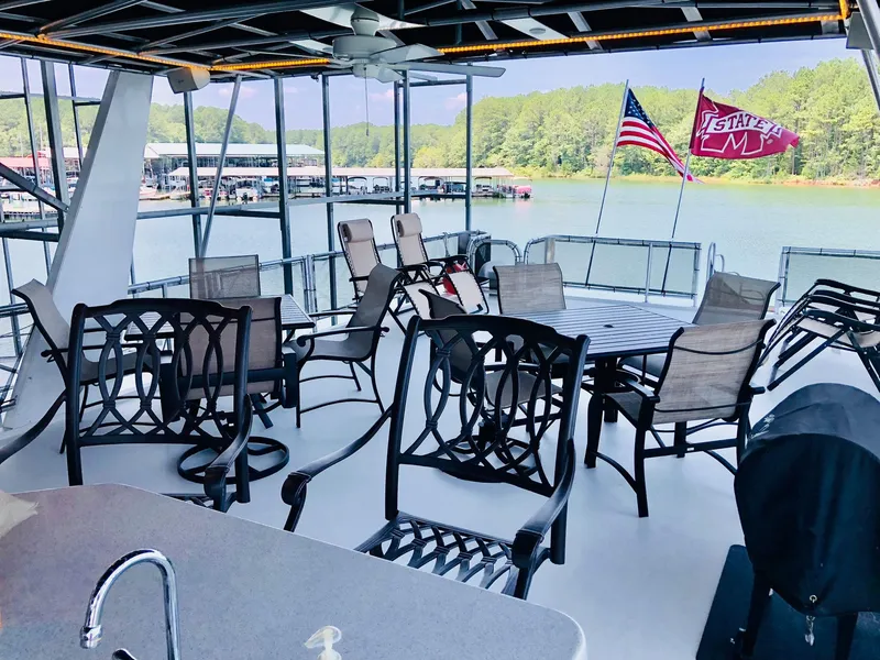 Slide: The Image of Upper deck of 2016 Thoroughbred 67x17 houseboat with outdoor seating and lake view. - 32
