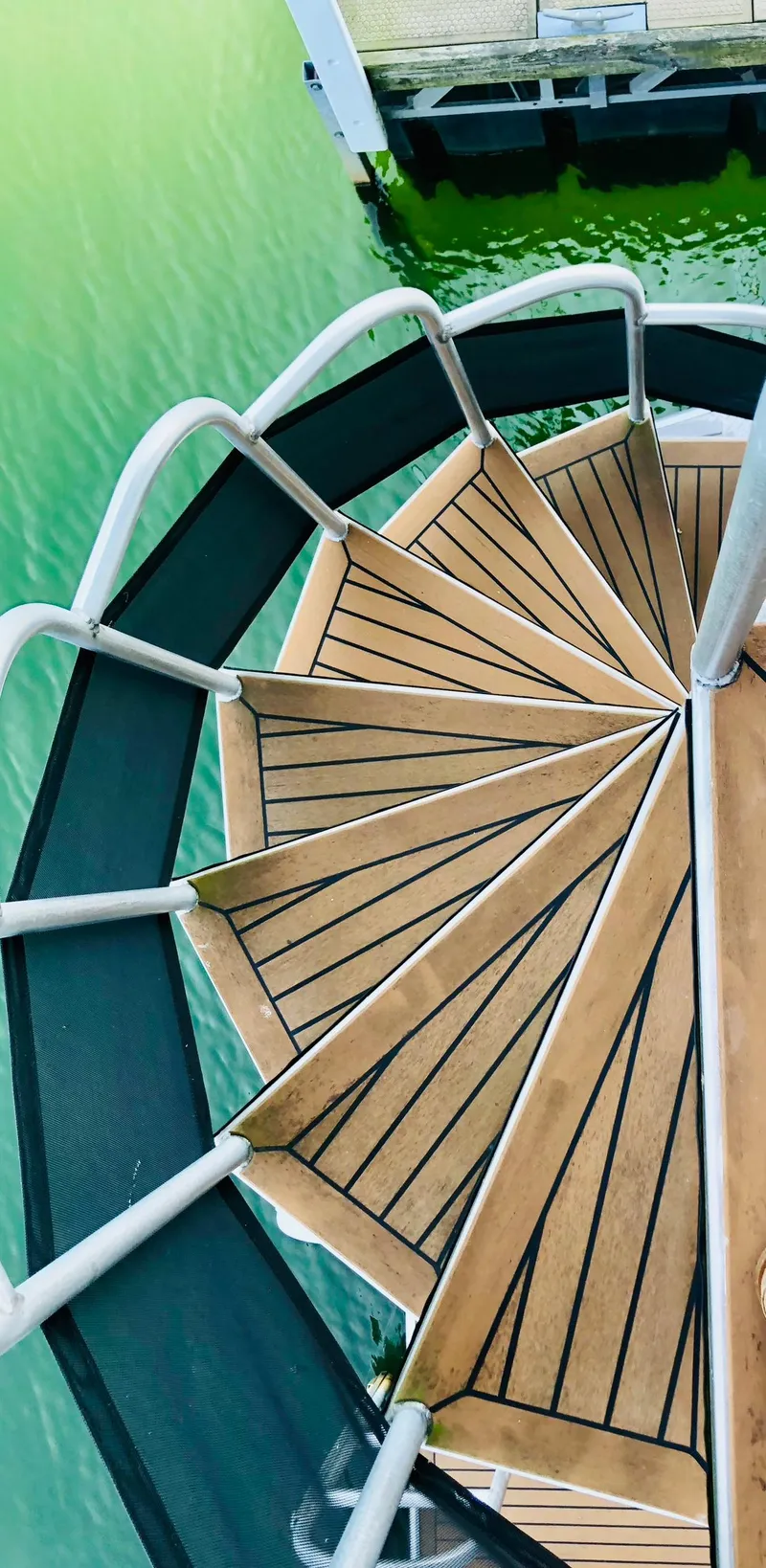 Slide: The Image of Spiral staircase on a Thoroughbred 67x17 yacht, 2016 model, overlooking green water. - 36