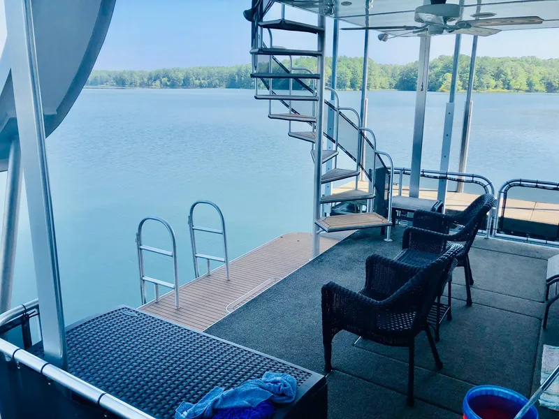 Slide: The Image of Houseboat deck with spiral staircase, lake view, and outdoor seating. Thoroughbred 67x17, 2016 model. - 39