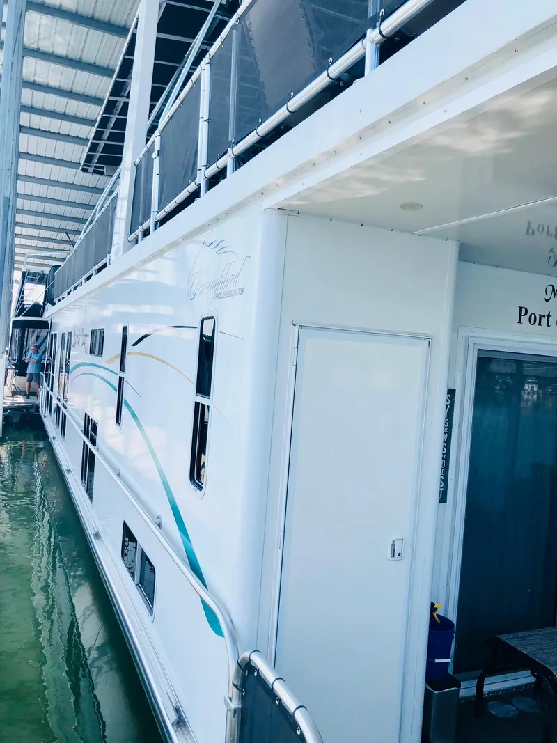 Slide: The Image of 2016 Thoroughbred 67x17 houseboat docked in a marina. - 44