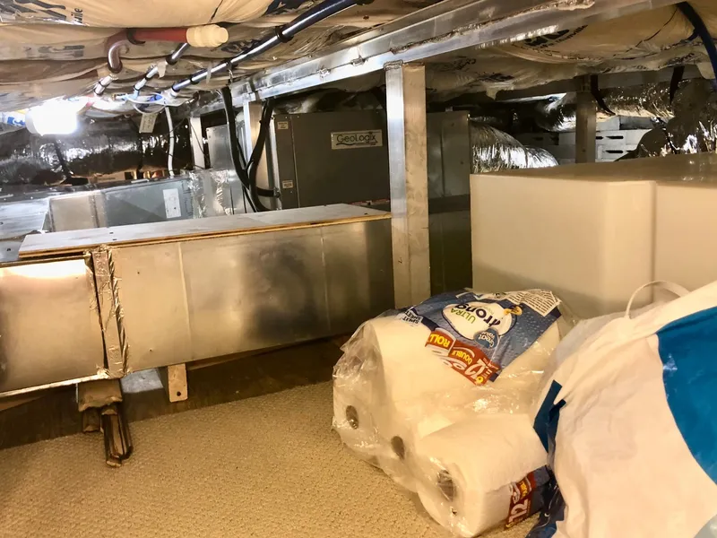 Slide: The Image of Thoroughbred 67x17 2016 model RV underbelly storage with HVAC system and supplies. - 45