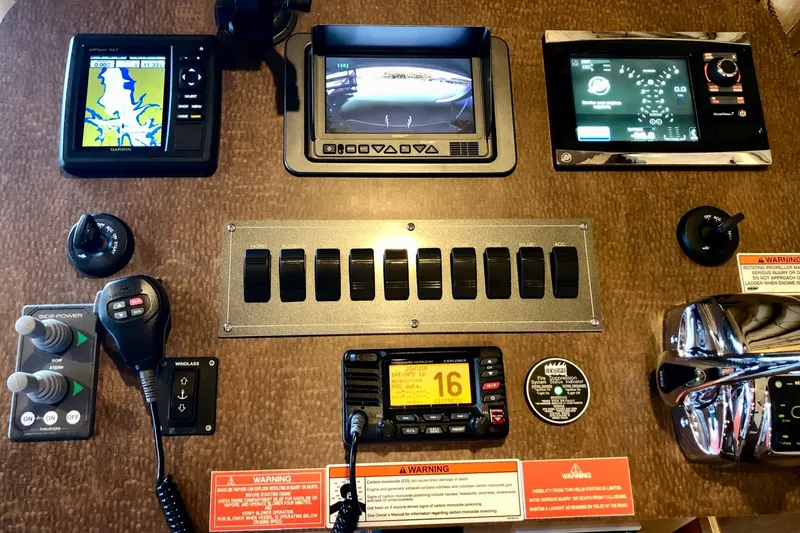 Slide: The Image of Control panel of a 2016 Thoroughbred 67x17 boat with navigation and communication equipment. - 48