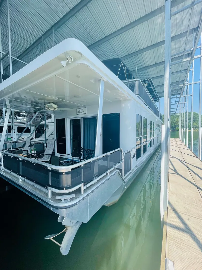 Slide: The Image of 2016 Thoroughbred 67x17 houseboat docked in a covered marina. - 8