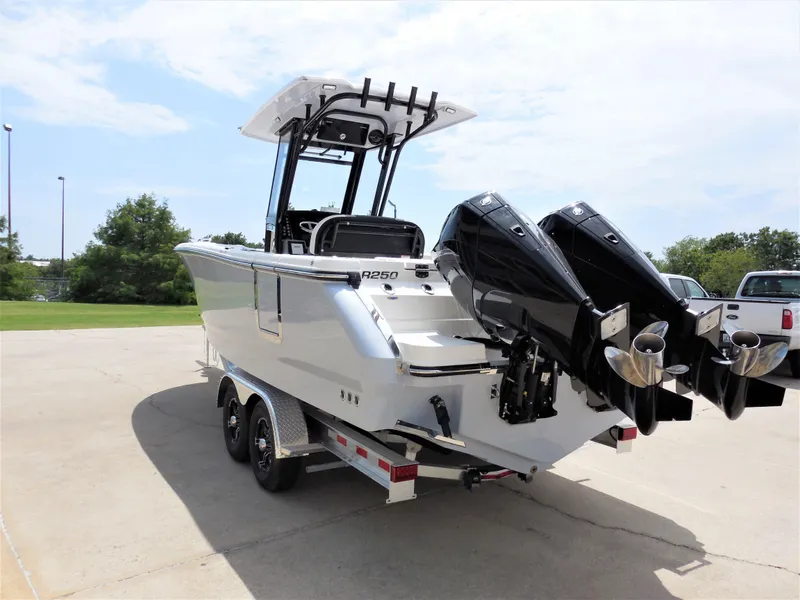 Slide: The Image of 2023 Robalo R250 boat on trailer with dual outboard engines. - 4