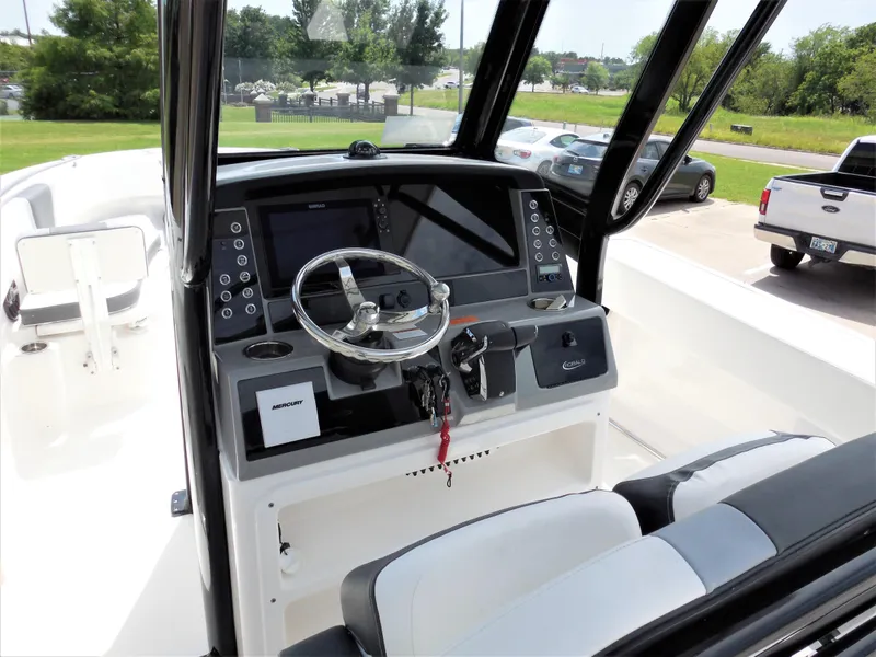 Slide: The Image of 2023 Robalo R250 boat dashboard with steering wheel and navigation controls. - 7