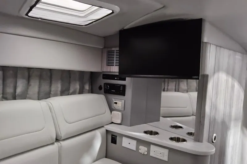 Slide: The Image of Interior of 2023 Formula 310 Sun Sport boat with TV and seating area. - 15