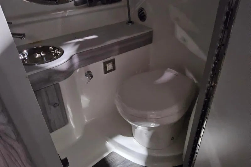 Slide: The Image of 2023 Formula 310 Sun Sport boat bathroom interior with sink and toilet. - 17