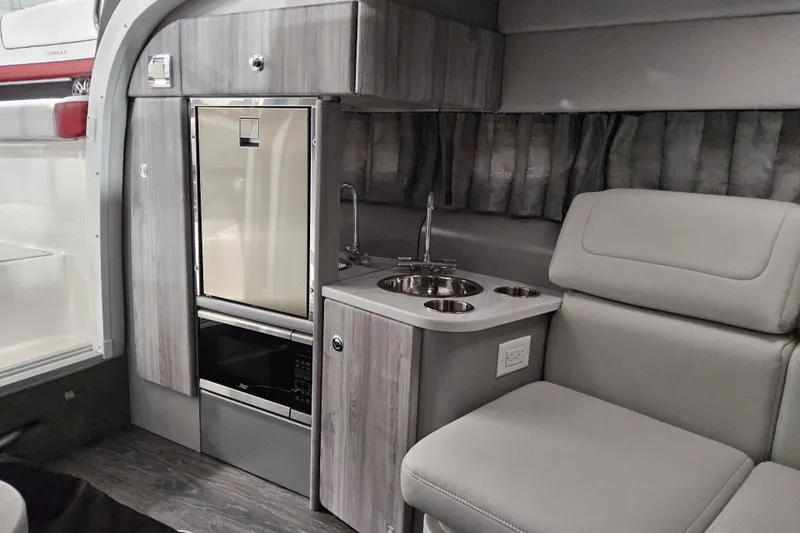 Slide: The Image of Interior of 2023 Formula 310 Sun Sport boat with kitchenette and seating area. - 18