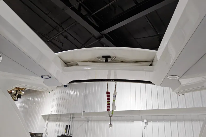 Slide: The Image of 2023 Formula 310 Sun Sport boat interior detail in a modern showroom. - 22
