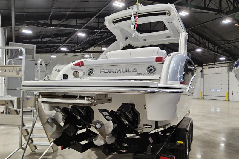 Slide: The Image of 2023 Formula 310 Sun Sport boat in showroom, rear view with dual propellers. - 24