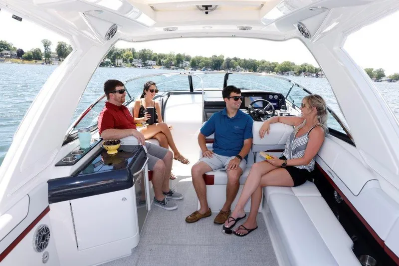 Slide: The Image of 2023 Formula 310 Sun Sport boat with people enjoying a sunny day on the water. - 6
