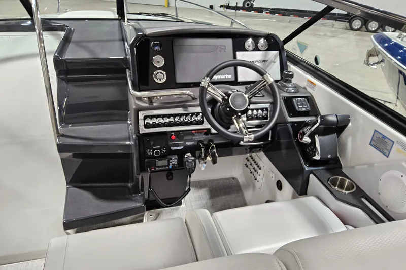 Slide: The Image of 2023 Formula 310 Sun Sport boat cockpit with modern steering and control panel. - 9