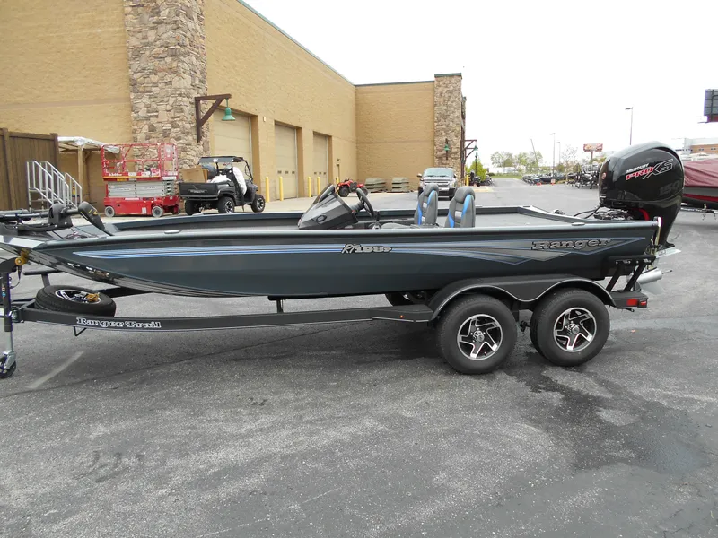 Slide: The Image of 2024 Ranger RT198P fishing boat on a trailer, parked outside a building. - 19