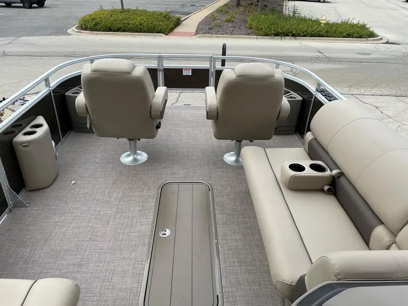 Slide: The Image of 2024 Sun Tracker Sportfish 24 XP3 pontoon boat interior with seating and storage. - 2