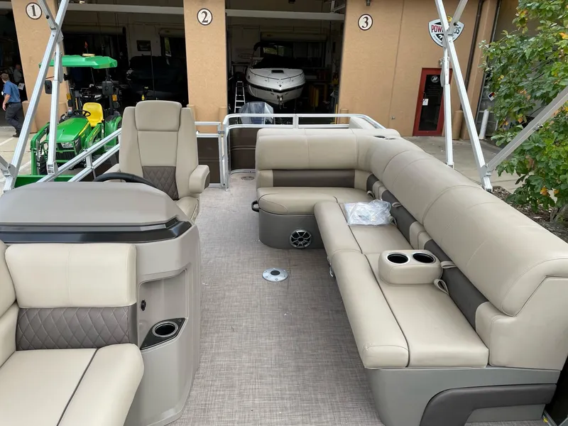 Slide: The Image of 2024 Sun Tracker Sportfish 24 XP3 pontoon boat interior with beige seating. - 3
