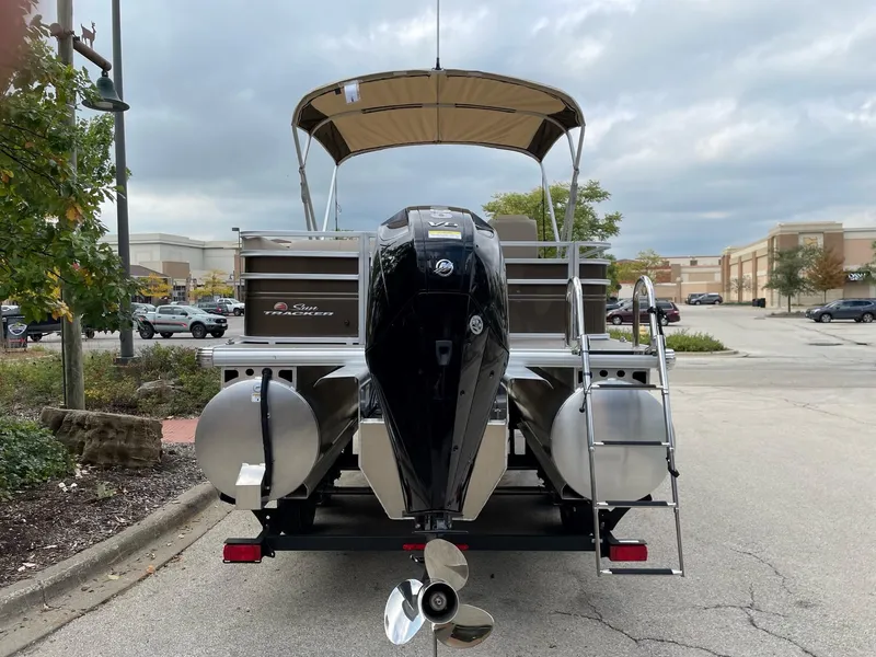 Slide: The Image of 2024 Sun Tracker Sportfish 24 XP3 pontoon boat rear view with outboard motor. - 8