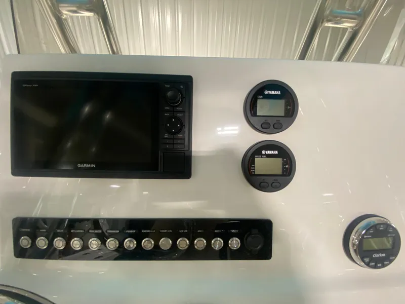Slide: The Image of 2024 Key West 239 FS boat dashboard with Garmin and Yamaha displays. - 12