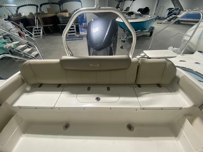 Slide: The Image of 2024 Key West 239 FS boat interior with cushioned seating and storage compartments. - 5