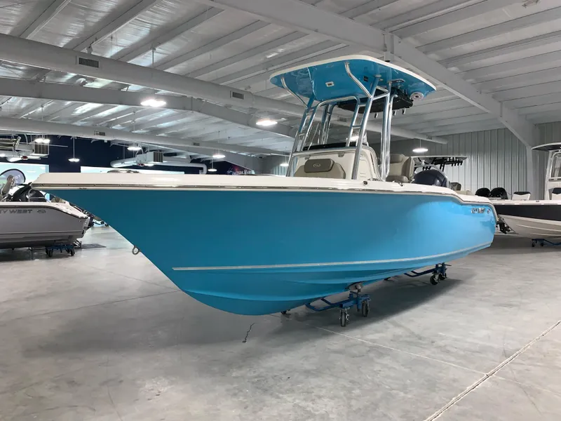 Slide: The Image of 2024 Key West 239 FS boat in showroom, blue hull, center console. - 1