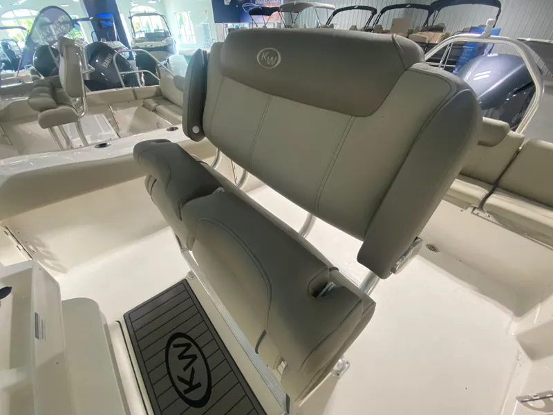 Slide: The Image of 2024 Key West 239 FS boat interior with cushioned seating and KW logo. - 10