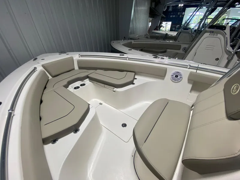 Slide: The Image of 2024 Key West 239 FS boat interior with beige seating and white deck. - 17
