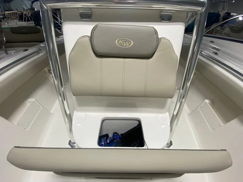 Slide: The Image of 2024 Key West 239 FS boat interior with cushioned seating and storage compartment. - 19
