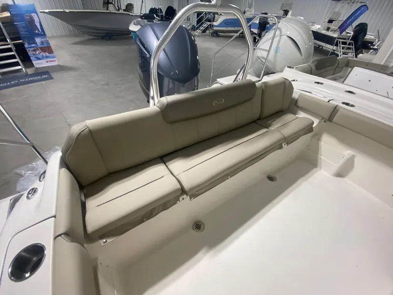 Slide: The Image of 2024 Key West 239 FS boat interior with beige seating in showroom. - 4