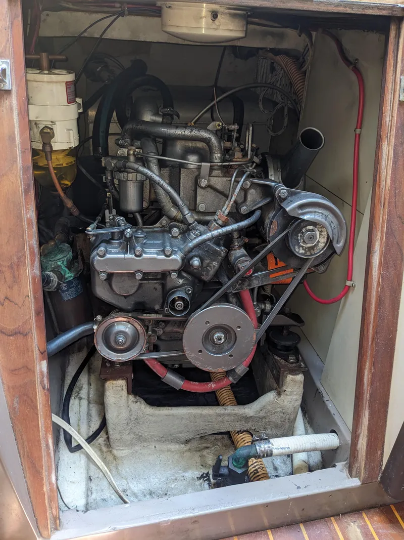 Slide: The Image of Engine compartment of a 1980 C&C 32 sailboat, showcasing mechanical components and wiring. - 22