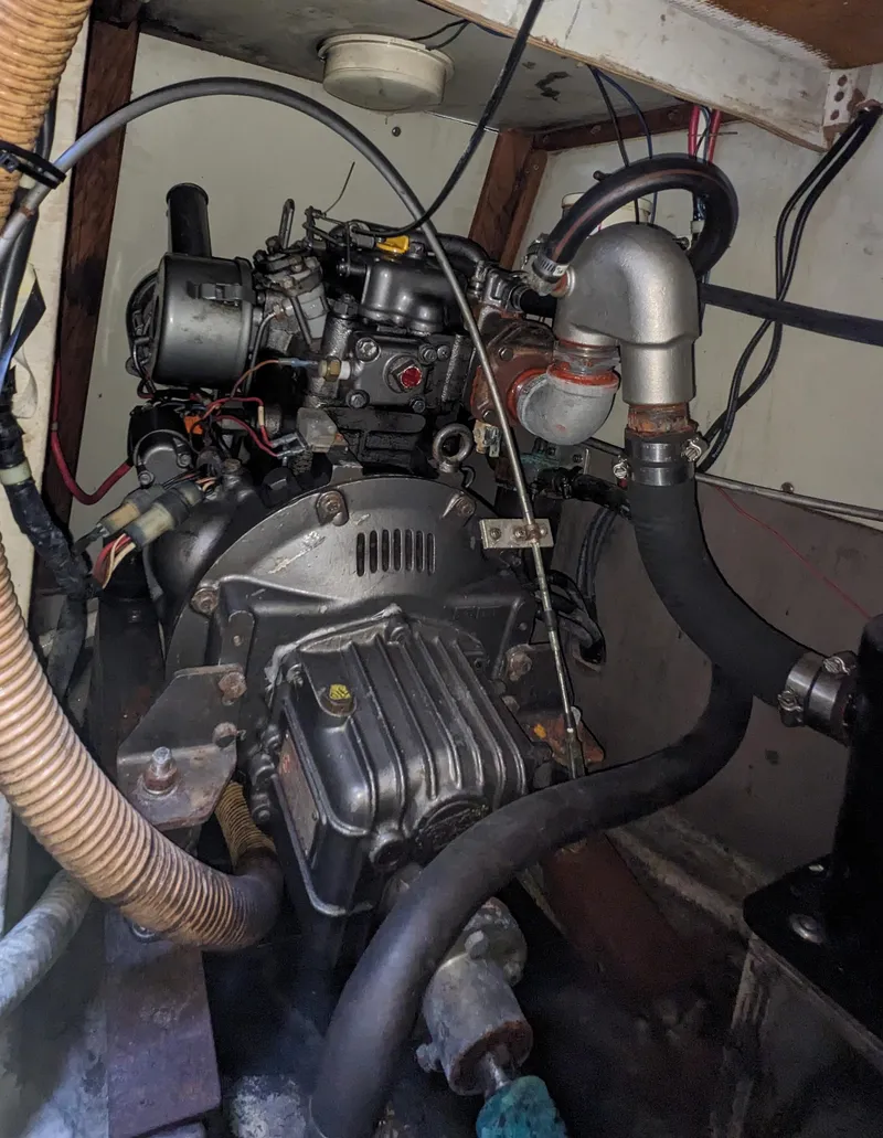 Slide: The Image of Engine compartment of a 1980 C&C 32 sailboat, showcasing mechanical components and wiring. - 23