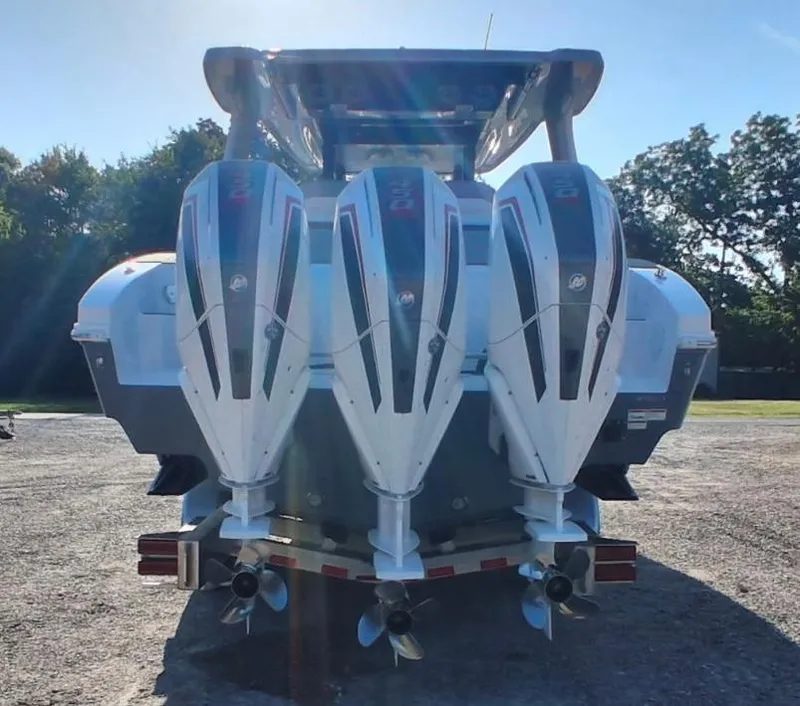 Slide: The Image of 2023 Fountain 38 SCX boat with triple outboard engines, rear view. - 2
