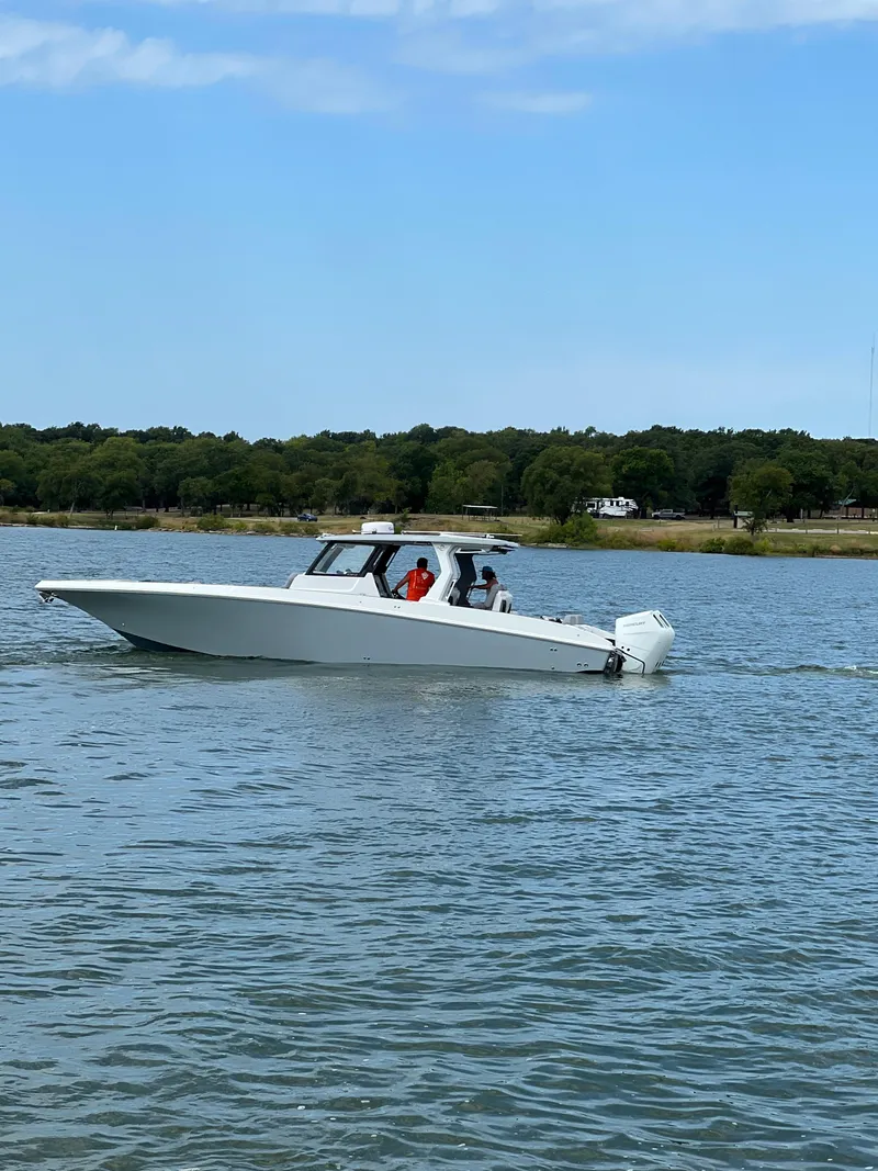 Slide: The Image of 2023 Fountain 38 SCX boat cruising on a calm lake. - 22