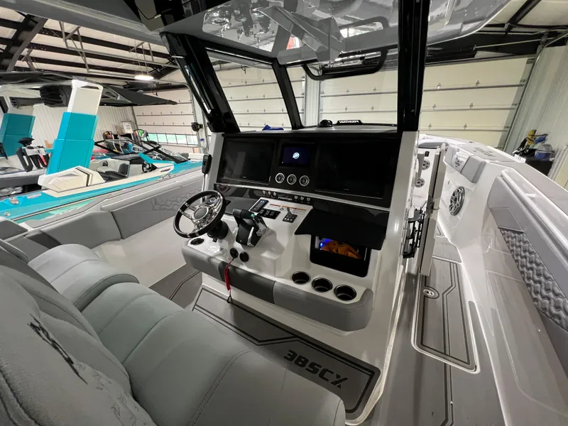 Slide: The Image of 2023 Fountain 38 SCX boat interior with modern dashboard and steering wheel. - 26