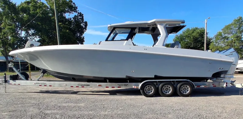Slide: The Image of 2023 Fountain 38 SCX boat on trailer, side view, outdoors, clear sky. - 3