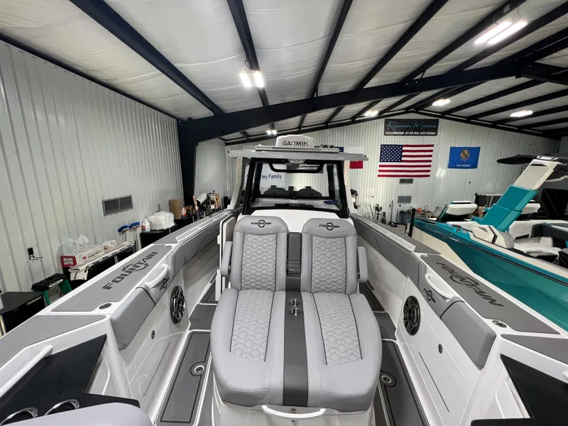 Slide: The Image of 2023 Fountain 38 SCX boat interior in a showroom with American flag. - 30