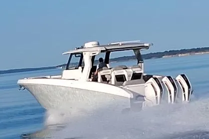 Slide: The Image of 2023 Fountain 38 SCX boat cruising on open water with multiple engines. - 32