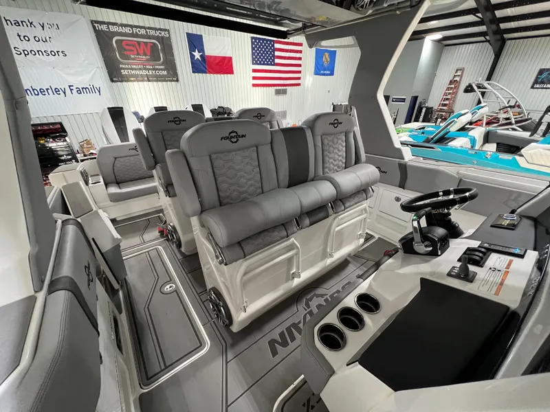 Slide: The Image of 2023 Fountain 38 SCX boat interior with plush seating and modern dashboard. - 37