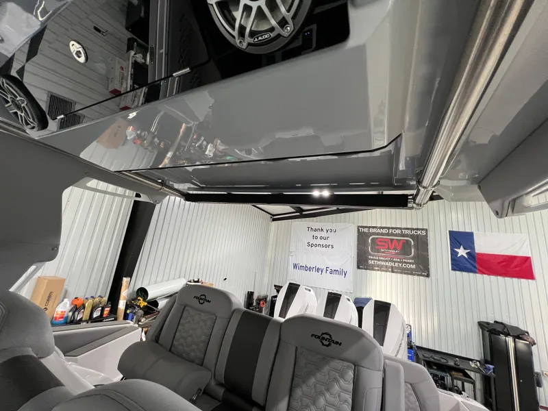 Slide: The Image of 2023 Fountain 38 SCX interior with luxury seating and Texas flag in the background. - 38