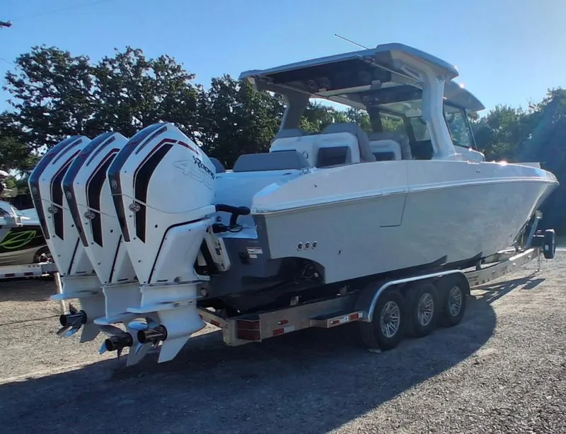 Slide: The Image of 2023 Fountain 38 SCX boat with four powerful outboard engines on a trailer. - 5