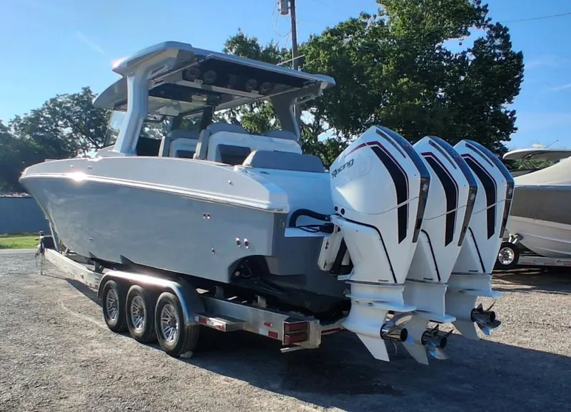 Slide: The Image of 2023 Fountain 38 SCX boat with triple outboard engines on a trailer. - 6