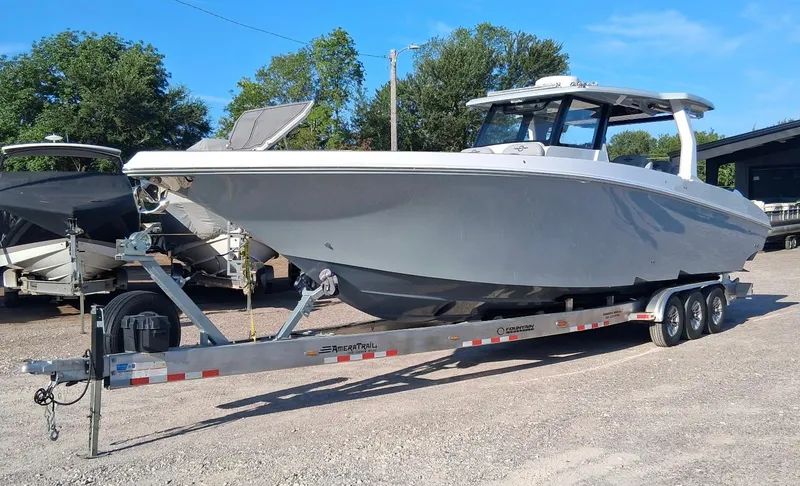 Slide: The Image of 2023 Fountain 38 SCX boat on trailer, parked outdoors, clear sky background. - 8