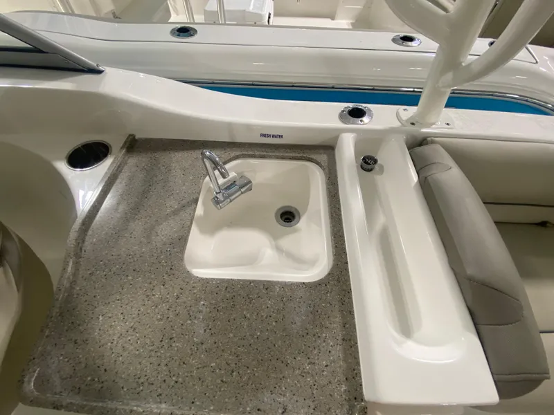 Slide: The Image of 2024 Key West 239 DFS boat interior with sink and seating area. - 11