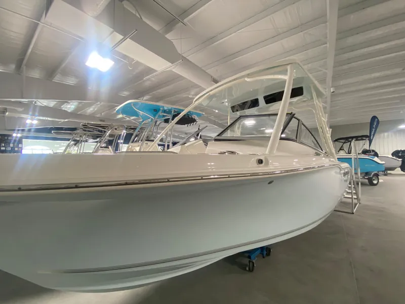 Slide: The Image of 2024 Key West 239 DFS boat displayed in a showroom. - 2