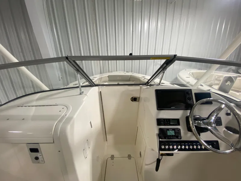 Slide: The Image of 2024 Key West 239 DFS boat dashboard and steering wheel in a showroom. - 21