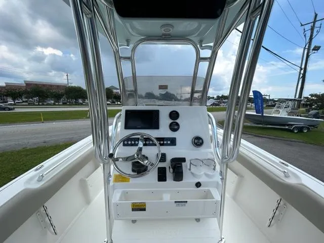 Slide: The Image of 2024 Key West 239 FS boat console with steering wheel and navigation controls. - 4