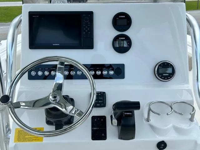 Slide: The Image of 2024 Key West 239 FS boat dashboard with Garmin navigation system and stainless steel steering wheel. - 5