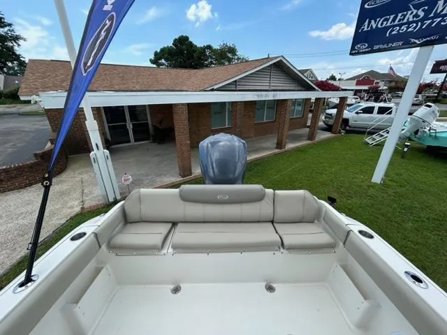 Slide: The Image of 2024 Key West 239 FS boat with rear seating and outboard motor at dealership. - 7