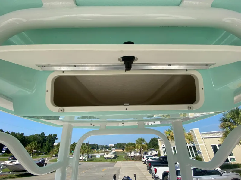Slide: The Image of 2024 Robalo 226 Cayman boat storage compartment with open hatch. - 16