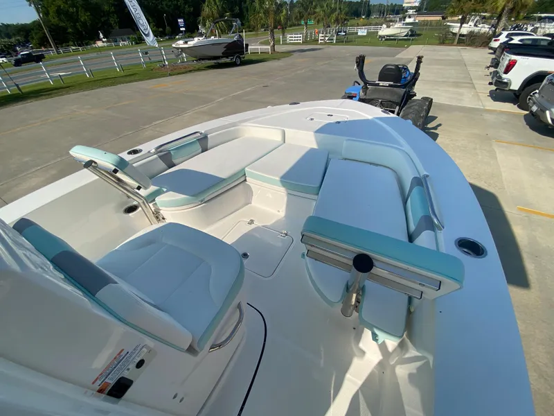 Slide: The Image of 2024 Robalo 226 Cayman boat interior with white and teal seating. - 17