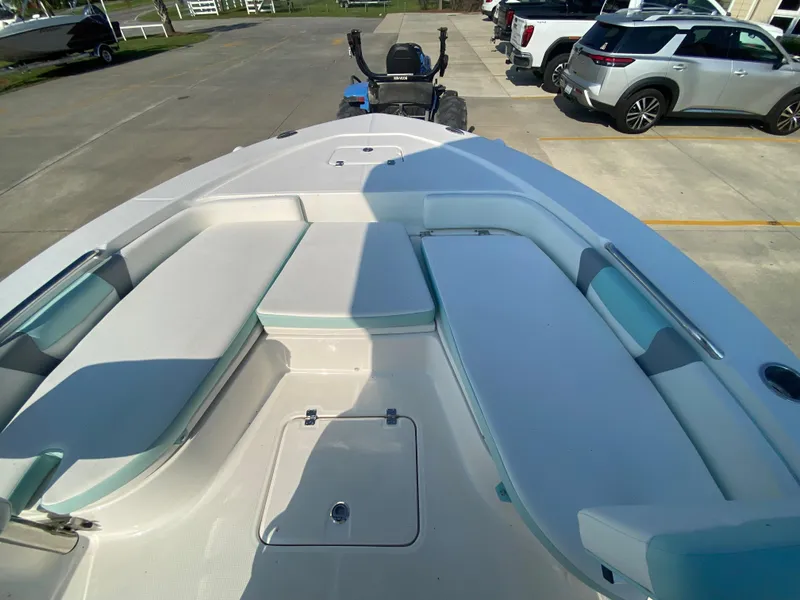 Slide: The Image of 2024 Robalo 226 Cayman boat interior with cushioned seating and storage compartments. - 20