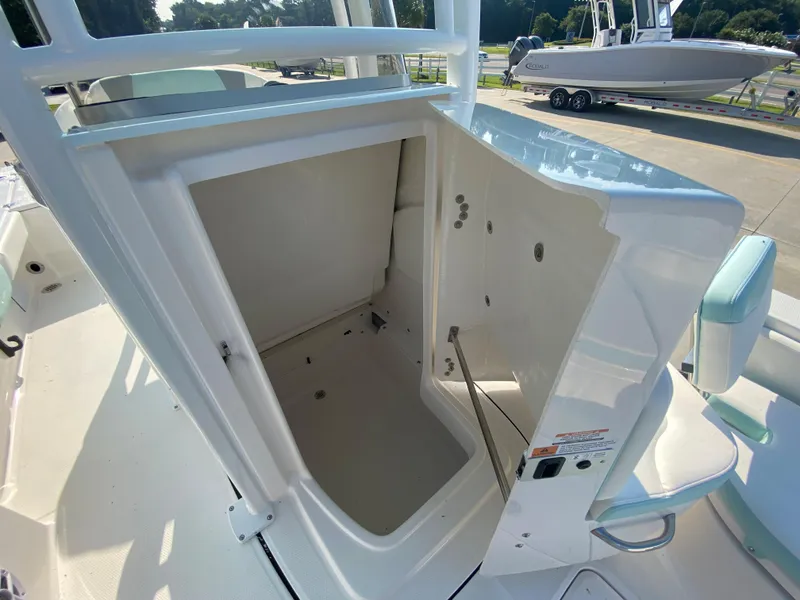 Slide: The Image of 2024 Robalo 226 Cayman boat storage compartment open. - 21